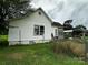 Exterior shot showing the side of the house, yard, and covered parking area at 211 Oak Dr, Shelby, NC 28150