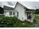 Side view of the home highlighting the white siding and covered porch with seating at 211 Oak Dr, Shelby, NC 28150
