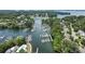 Serene aerial view showcasing the lake community with waterfront homes, lush greenery, and multiple private boat docks at 21319 Baltic Dr, Cornelius, NC 28031