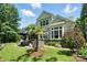 Picturesque backyard featuring a lush lawn, outdoor seating, and charming landscaping at 21319 Baltic Dr, Cornelius, NC 28031