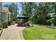 Backyard with brick patio, stone grill, and seating area at 21319 Baltic Dr, Cornelius, NC 28031
