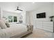This bedroom offers two beds, a ceiling fan, and a built-in dresser with modern lighting at 21319 Baltic Dr, Cornelius, NC 28031