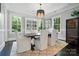 Elegant dining room with hardwood floors, natural light, stylish furnishings, and a built-in display cabinet at 21319 Baltic Dr, Cornelius, NC 28031