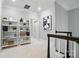Upstairs hallway features decorative shelving, neutral walls, and white trim at 21319 Baltic Dr, Cornelius, NC 28031