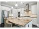 Gourmet kitchen with granite counters, white cabinets, and stainless steel appliances at 21319 Baltic Dr, Cornelius, NC 28031