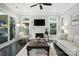 Cozy living room with fireplace, dark wood floors and bright natural light at 21319 Baltic Dr, Cornelius, NC 28031