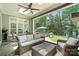 Covered patio featuring comfortable seating, outdoor dining, and serene views of the landscaped backyard at 21319 Baltic Dr, Cornelius, NC 28031