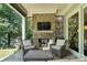 Covered porch featuring fireplace, outdoor seating, and ceiling fan at 21319 Baltic Dr, Cornelius, NC 28031