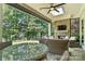 Screened porch with stone fireplace, ceiling fan, skylight, and patio furniture at 21319 Baltic Dr, Cornelius, NC 28031