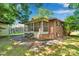 Backyard view of the brick home with a screened porch and mature trees at 226 S Morrow Ave, Albemarle, NC 28001