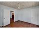 Bedroom featuring hardwood floors, neutral paint, and two closets at 226 S Morrow Ave, Albemarle, NC 28001
