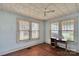Cozy bedroom with hardwood floors, two large windows, and a ceiling fan at 226 S Morrow Ave, Albemarle, NC 28001
