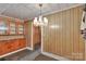 Dining room with hardwood floors, wood cabinets, vintage fixtures, and paneling at 226 S Morrow Ave, Albemarle, NC 28001