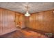 Room featuring wood paneling, hardwood floors, and a chandelier at 226 S Morrow Ave, Albemarle, NC 28001
