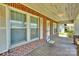 Charming front porch with brick siding and a wooden deck at 226 S Morrow Ave, Albemarle, NC 28001