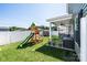 Spacious backyard featuring a play set, a covered patio, and lush green grass at 2526 Snow Creek Ne Rd, Hickory, NC 28601