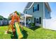 Lush backyard featuring a playset, covered patio, and a privacy fence at 2526 Snow Creek Ne Rd, Hickory, NC 28601