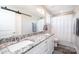 Bathroom featuring dual sinks with granite countertops and white cabinets, plus a shower at 2526 Snow Creek Ne Rd, Hickory, NC 28601