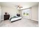 Bright primary bedroom with a ceiling fan and a large window overlooking the trees at 2526 Snow Creek Ne Rd, Hickory, NC 28601