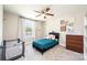 Cozy bedroom with neutral tones, plush carpet, ceiling fan, and window for natural light at 2526 Snow Creek Ne Rd, Hickory, NC 28601