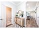 Inviting entryway featuring stylish decor, a convenient half-bath, and a glimpse of the modern kitchen at 2526 Snow Creek Ne Rd, Hickory, NC 28601