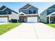 Charming two-story home with a stone facade, light gray siding and a spacious driveway at 2526 Snow Creek Ne Rd, Hickory, NC 28601