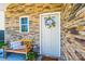 Inviting front porch with stone accents, wreath, and a bench perfect for relaxing at 2526 Snow Creek Ne Rd, Hickory, NC 28601