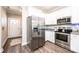 Modern kitchen boasts stainless steel appliances, white cabinets, and granite countertops at 2526 Snow Creek Ne Rd, Hickory, NC 28601