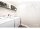Functional laundry room with a washer, dryer, and shelving for storage at 2526 Snow Creek Ne Rd, Hickory, NC 28601
