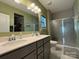 Bathroom featuring a dual sink vanity, walk-in shower, and modern fixtures at 284 Old Harbor Dr, Mount Gilead, NC 27306