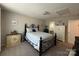 Comfortable bedroom with iron bed frame, neutral walls, and carpeted floors at 284 Old Harbor Dr, Mount Gilead, NC 27306