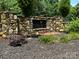 Stone entrance to The Tillery Tradition Country Club with lush landscaping and manicured mulch beds at 284 Old Harbor Dr, Mount Gilead, NC 27306