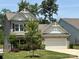 Charming two-story home featuring stone accents, a well-manicured lawn, and an attached two-car garage at 284 Old Harbor Dr, Mount Gilead, NC 27306