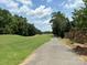 Well-manicured golf course view with lush green fairways, mature trees, and scenic surroundings at 284 Old Harbor Dr, Mount Gilead, NC 27306