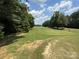 Lush golf course displaying rolling hills, mature trees, and verdant green grass at 284 Old Harbor Dr, Mount Gilead, NC 27306