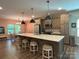 Modern kitchen with stainless steel appliances, large island with seating, and stylish pendant lighting at 284 Old Harbor Dr, Mount Gilead, NC 27306