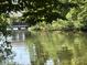 Scenic view of the lake showcasing a boat dock and an idyllic waterside setting at 284 Old Harbor Dr, Mount Gilead, NC 27306