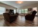 Open-concept living room featuring luxury vinyl plank flooring, neutral paint, and ample natural light at 284 Old Harbor Dr, Mount Gilead, NC 27306