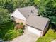 Charming brick home with an attached two-car garage, and a well-maintained lawn with mature landscaping at 320 Magnolia St, Davidson, NC 28036