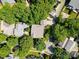 Overhead aerial shot of the house surrounded by lush trees in a residential neighborhood at 320 Magnolia St, Davidson, NC 28036