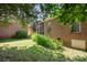 Green grass area and brick home exterior view featuring a screened-in porch and lush landscaping at 320 Magnolia St, Davidson, NC 28036