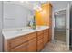 Bathroom features double sink vanity, large mirror, and wood cabinets at 320 Magnolia St, Davidson, NC 28036
