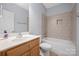 Bathroom features single sink vanity, tile floors, and shower-tub combo at 320 Magnolia St, Davidson, NC 28036