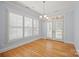 Dining area with hardwood floors, plantation shutters, and modern chandelier at 320 Magnolia St, Davidson, NC 28036