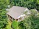 A beautiful aerial view of the brick house surrounded by lush green trees and well-maintained landscaping at 320 Magnolia St, Davidson, NC 28036