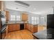 Well-appointed kitchen with granite countertops, wooden cabinets, and stainless steel appliances, offering functionality and style at 320 Magnolia St, Davidson, NC 28036