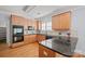 Kitchen with hardwood floors, wood cabinetry, granite countertops, and built-in stainless appliances at 320 Magnolia St, Davidson, NC 28036