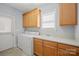 Laundry room with built-in cabinets, utility sink, and washer/dryer hookups at 320 Magnolia St, Davidson, NC 28036