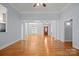 Spacious living room featuring hardwood floors, large windows, and elegant architectural columns at 320 Magnolia St, Davidson, NC 28036