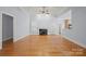Bright living room featuring hardwood floors, a cozy fireplace, and abundant natural light from large windows at 320 Magnolia St, Davidson, NC 28036